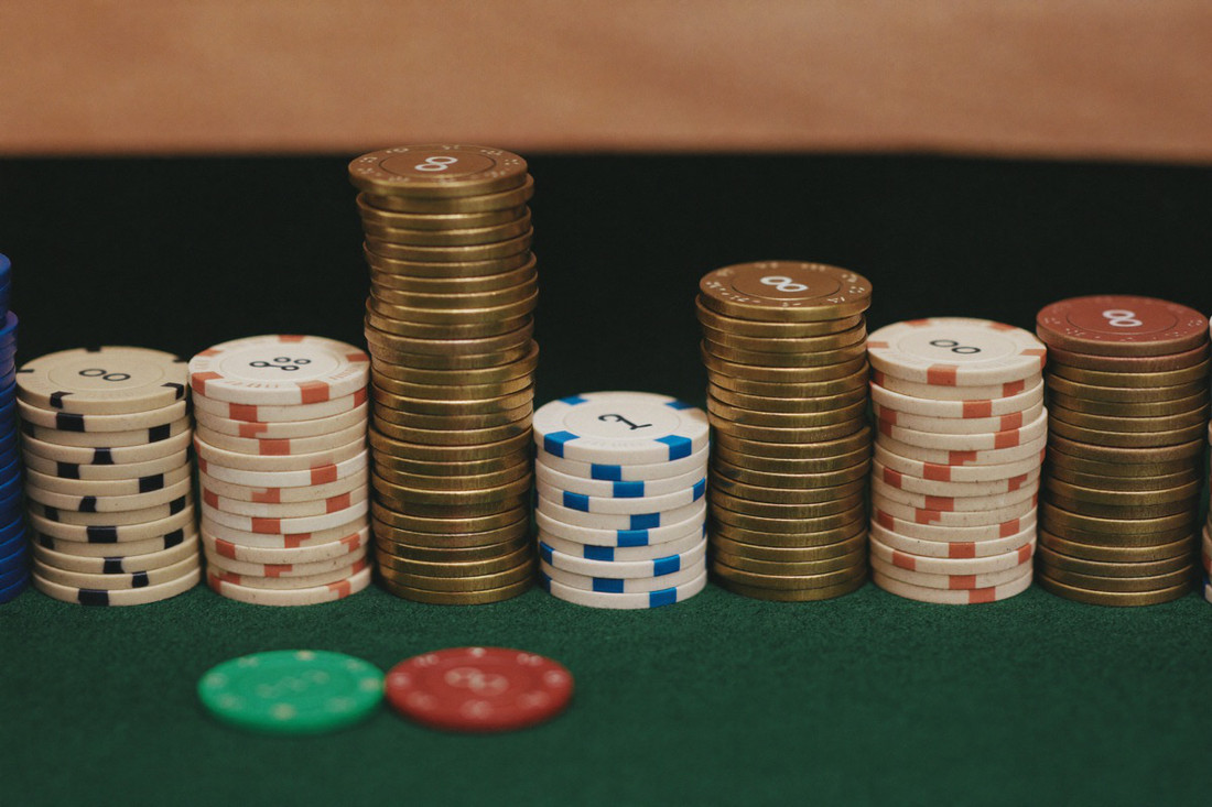 Rows of coloured chips stacked in towers across green baize